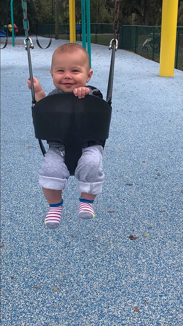 Sasha is registered to the contest to win money with this photo: asphalt, baby, baby_toddler_clothing, black, child, city, electric_blue, fun, grass, happy, human_leg, joy, leisure, person, playground, recreation, road_surface, sleeve, smile, swing