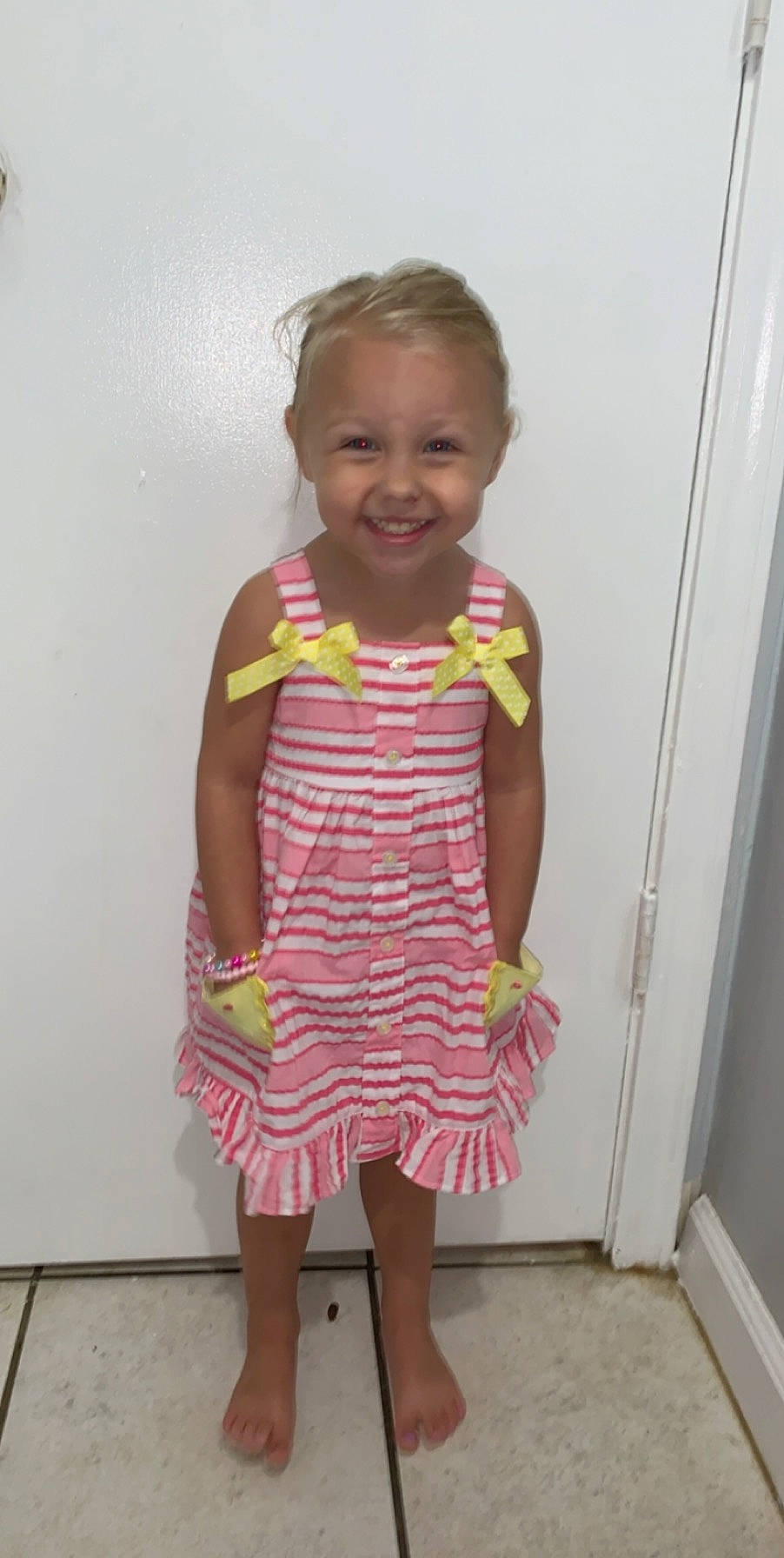 Ansley is registered to the contest to win money with this photo: baby_toddler_clothing, child, clothing, day_dress, dress, joy, pattern, person, pink, standing, textile, toddler