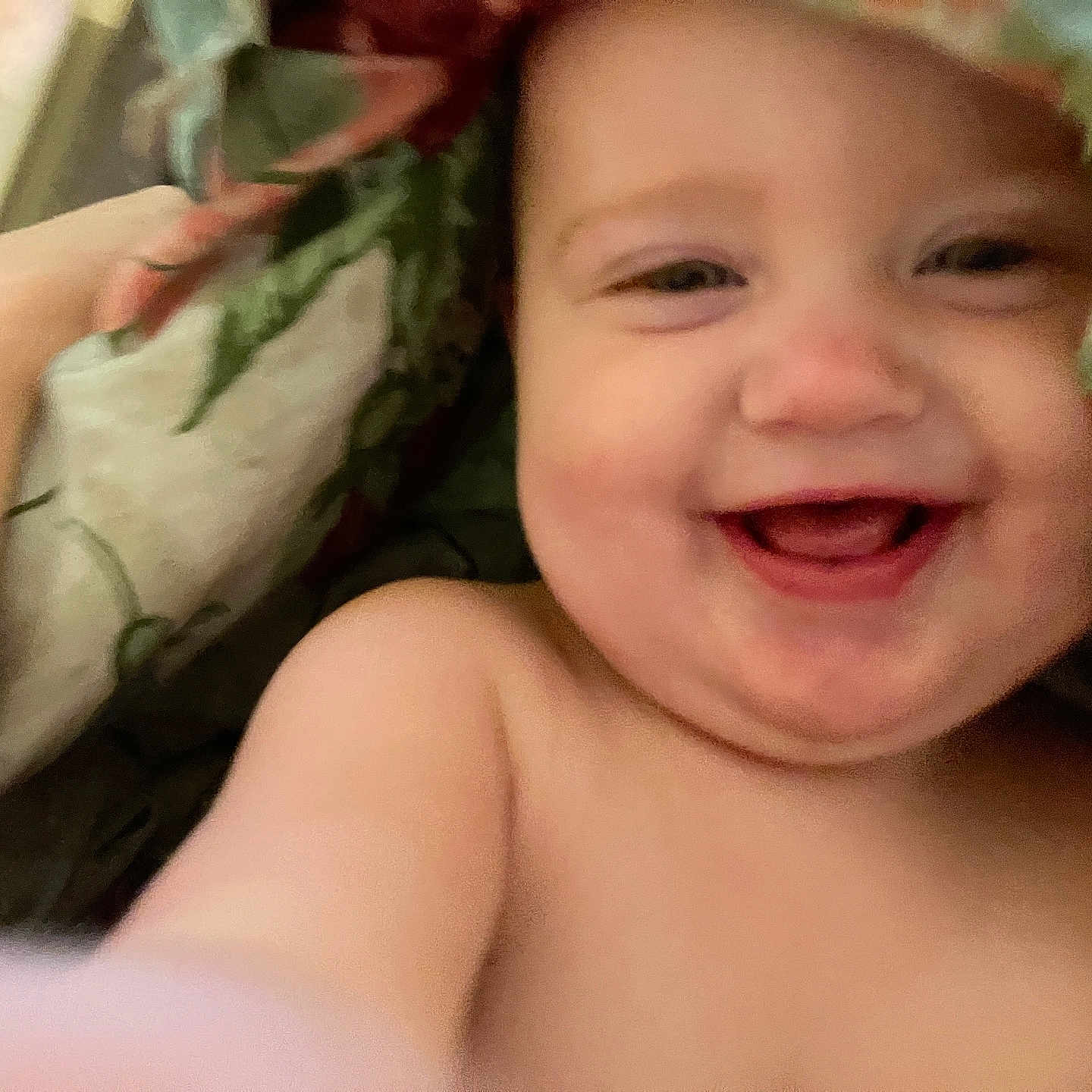 Maysie is registered to the contest to win money with this photo: baby, blanket, child, closeup, comfort, cozy, cute, expression, face, hand, happy, indoors, infant, natural, playful, portrait, skin, smiling, soft, young