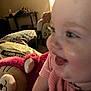 Maysie is registered to the contest to win money with this photo: baby, child, smile, face, plush_toy, stuffed_animal, indoor, cozy, furniture, toy, pink_clothing, happy, closeup, person, head, couch, pillow, room, cheerful, infant