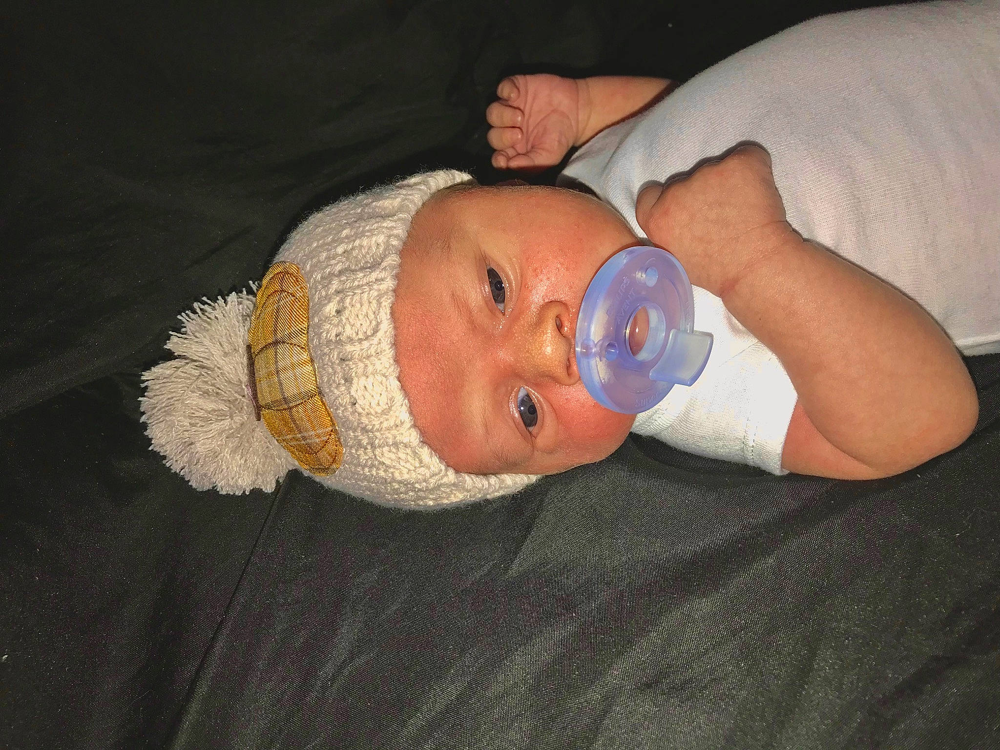 Jae is registered to the contest to win money with this photo: baby, baby_products, baby_toddler_clothing, beanie, cheek, child, comfort, ear, hat, head, headgear, headwear, human_body, knit_cap, linens, nail, person, room, skin, thumb