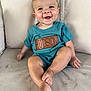baby, child, smiling, happy, sitting, cushion, clothing, shirt, indoor, face, feet, toes, cute, infant, portrait, skin, hair, young, person, relaxing