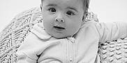 Jesse is registered to the contest to win money with this photo: baby, black_and_white, child, closeup, clothing, cushion, cute, expression, face, indoors, infant, knitted, looking, pants, portrait, seated, soft_lighting, sweatshirt, texture, young
