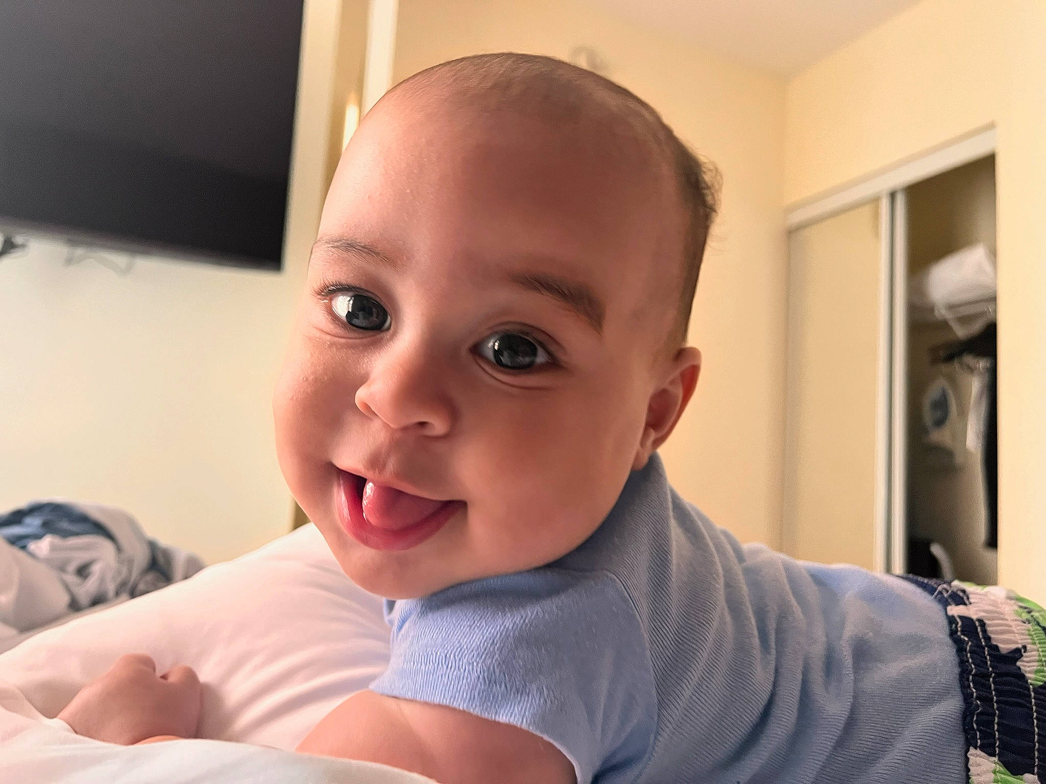 Julian is registered to the contest to win money with this photo: baby, cheek, comfort, eyebrow, eyelash, finger, forehead, gesture, happy, iris, jaw, lip, mouth, neck, nose, person, shoulder, sleeve, smile, toddler