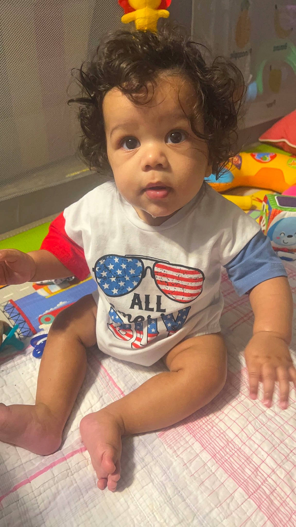 Tylan is registered to the contest to win money with this photo: baby, baby_toddler_clothing, cheek, child, chin, face, fun, hair, hairstyle, happy, head, iris, mouth, nose, pattern, person, sitting, skin, sleeve, t_shirt