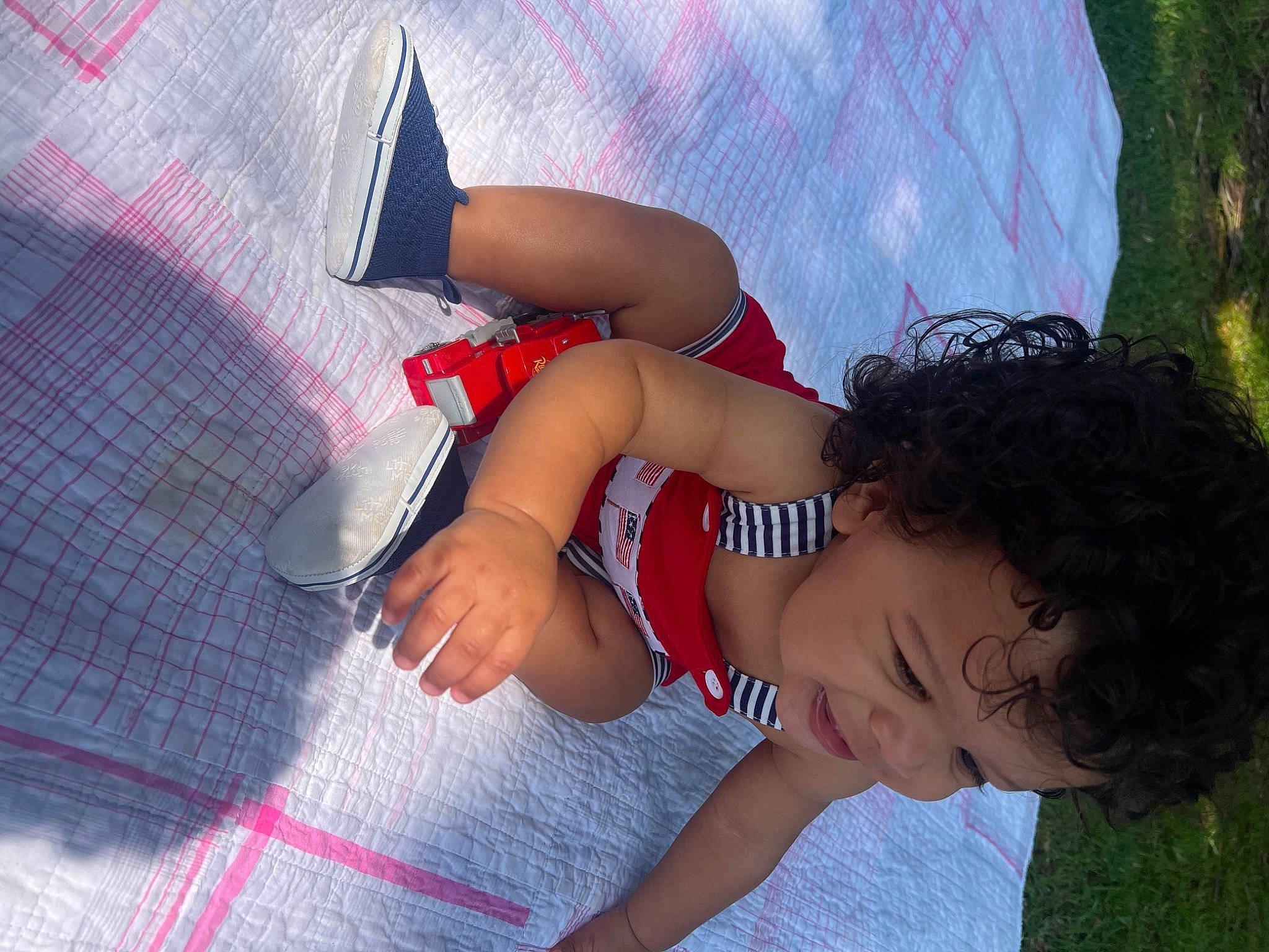 Tylan is registered to the contest to win money with this photo: black_hair, child, cool, elbow, electric_blue, flooring, foot, fun, grass, happy, human_leg, joint, knee, leg, leisure, pattern, people_in_nature, person, thigh, toddler