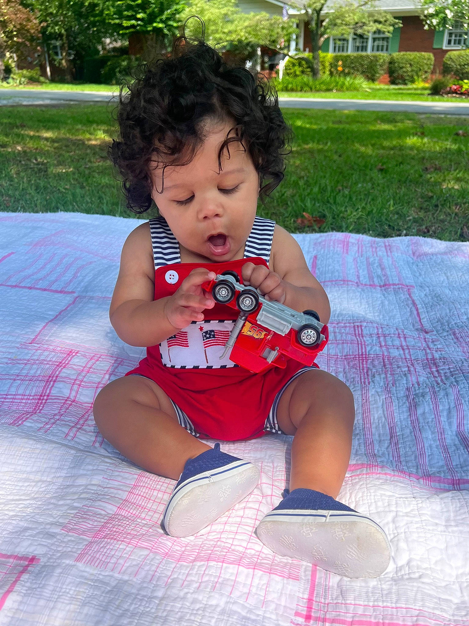 Tylan is registered to the contest to win money with this photo: baby, baby_toddler_clothing, child, foot, fun, grass, happy, human_leg, knee, leisure, person, pink, plant, recreation, sandal, sitting, sneakers, sock, thigh, toddler