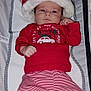 baby, infant, red_clothing, striped_pants, santa_hat, reindeer_slippers, changing_pad, holiday, christmas, cute, lying_down, indoors, child, face, feet, socks, festive, winter, person, portrait