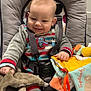 Edzyo participe au concours pour gagner de l'argent avec cette photo : baby, infant, child, car_seat, baby_seat, onesie, striped_clothing, toys, plush_toy, giraffe_teether, soft_book, safety_harness, socks, seat_padding, smile, happy, indoor, neutral_background, playtime, cute
