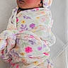 Jhournee is registered to the contest to win money with this photo: baby, sleeping, blanket, floral_pattern, hood, soft_texture, wrapped, infant, rosy_cheeks, peaceful, cute, toddler, child, cozy, indoor, portrait, newborn, clothing, fabric, headwear