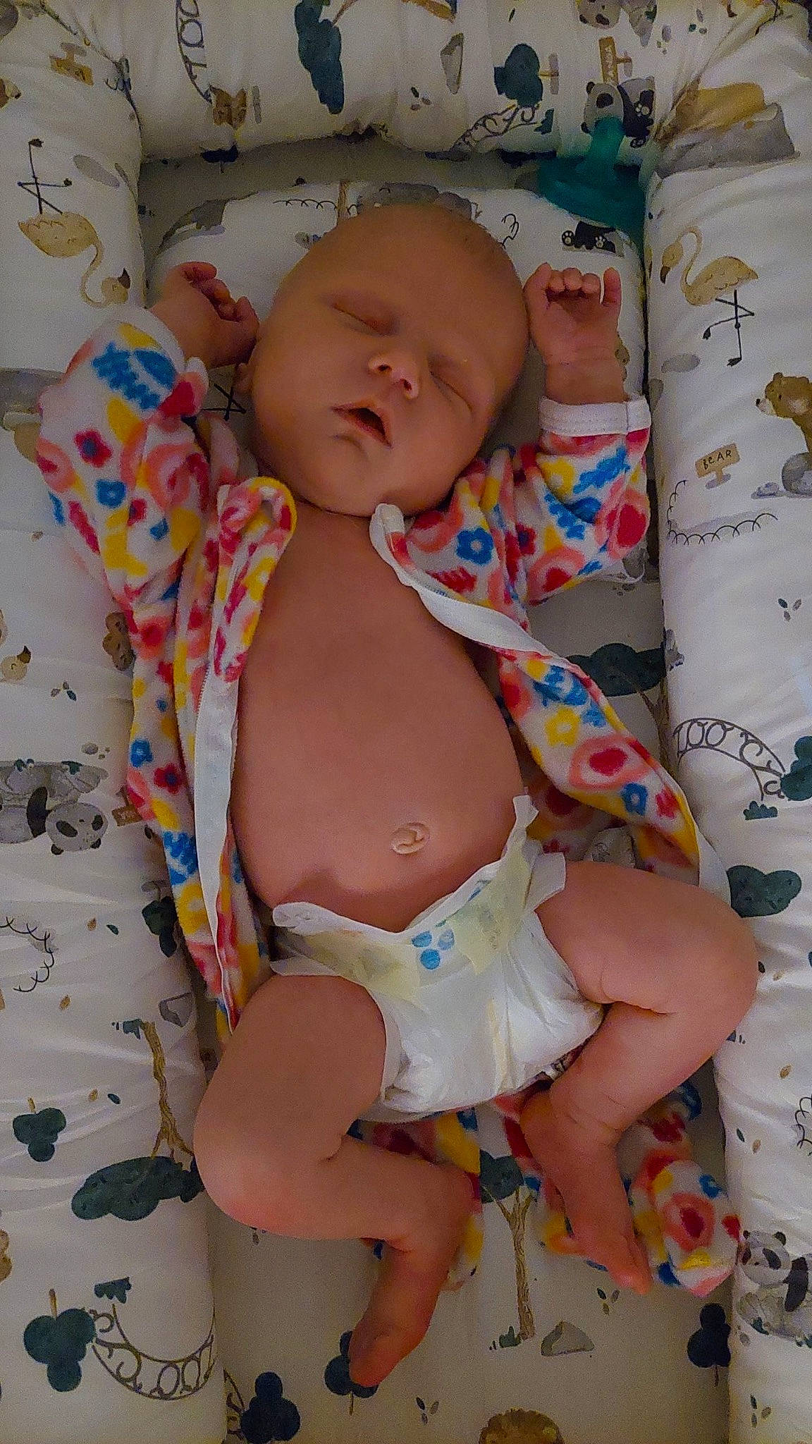 Olivia is registered to the contest to win money with this photo: abdomen, baby, baby_toddler_clothing, chest, child, comfort, diaper, finger, human_body, human_leg, knee, linens, pattern, person, pink, skin, stomach, textile, thigh, toddler