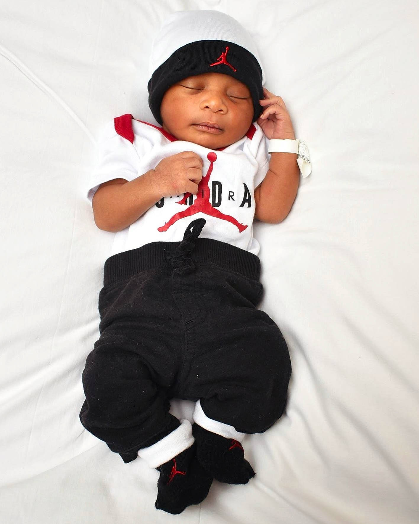 Mekhai joined the competition — help win amazing prizes! baby, baby_toddler_clothing, baseball_cap, cap, carmine, child, elbow, eye, face, flash_photography, fun, gesture, glove, happy, headwear, logo, person, sitting, sleeve, sportswear