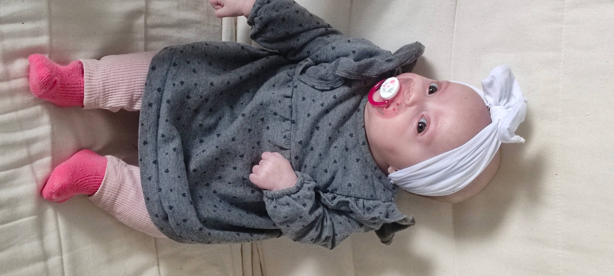Leyah participe au concours pour gagner de l'argent avec cette photo : arm, baby, baby_products, baby_toddler_clothing, cheek, child, comfort, fur, gesture, grey, hand, happy, headwear, human_body, linens, person, pink, sitting, skin, sleeve