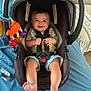 River joined the competition — help win amazing prizes! baby, car_seat, smile, child, toy, orange_crab, clothing, safety_harness, blue_shorts, indoor, fabric, foot, hand, furniture, person, seat_belt, happy, head, patterned_rug, blanket