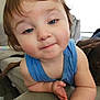 toddler, child, blue_tank_top, face, hair, arm, couch, living_room, dog, pet, furniture, floor, window, light, skin, expression, person, indoors, curious, smile