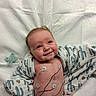 baby, infant, smiling, medical, electrodes, blanket, cactus_pattern, diaper, hospital, cute, skin, face, lying_down, healthcare, monitoring, newborn, child, expression, indoors, resting