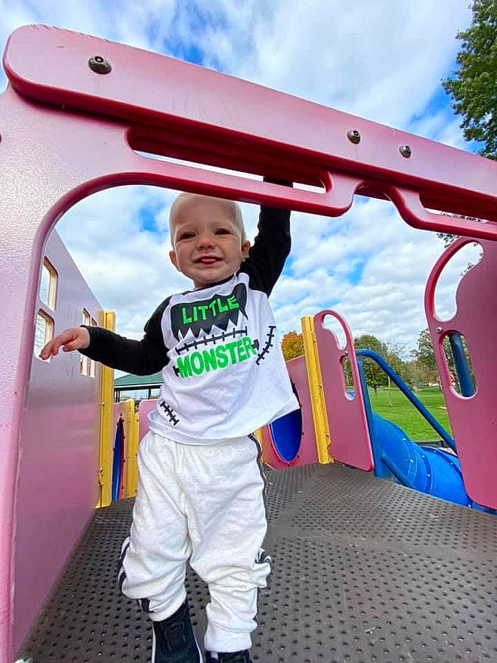 Cecil is registered to the contest to win money with this photo: automotive_exterior, baby_toddler_clothing, child, chute, cloud, fun, hat, jacket, joy, leisure, outdoor_play_equipment, person, personal_protective_equipment, playground, playground_slide, recreation, sky, sleeve, smile, t_shirt