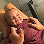 baby, smiling, hands, maroon_clothing, infant, person, window_blinds, fan, indoor, happy, face, skin, cute, cozy, human, child, comfort, toddler, holding, joy