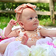 Rhylee joined the competition — help win amazing prizes! baby, infant, flower, pink_bow, outdoor, nature, greenery, cute, portrait, child, summer, sunlight, soft, skin, happy, sitting, closeup, headband, colorful, garden