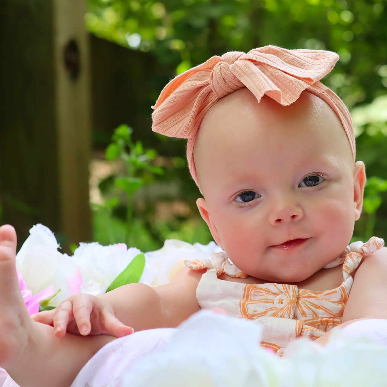 Rhylee joined the competition — help win amazing prizes! baby, baby_clothing, bow, child, closeup, cute, flower, foot, greenery, hand, headband, infant, nature, outdoor, peaceful, portrait, relaxed, skin, smile, soft