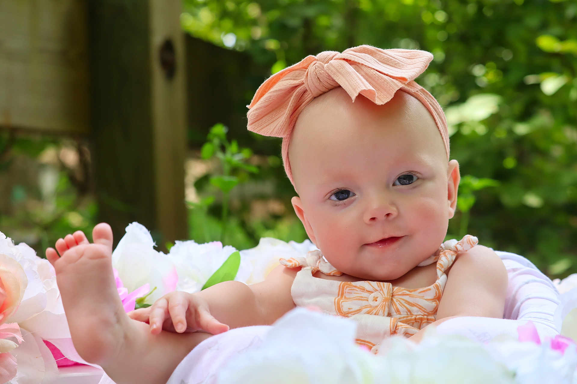 Rhylee joined the competition — help win amazing prizes! baby, infant, headband, bow, flower, outdoor, greenery, portrait, cute, skin, hand, foot, smile, nature, baby_clothing, soft, relaxed, closeup, child, peaceful
