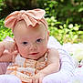 Rhylee is registered to the contest to win money with this photo: baby, child, headband, bow, flower, cushion, greenery, outdoor, portrait, infant, cute, relaxing, pink, white, nature, soft, skin, face, person, baby_clothes