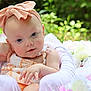 baby, child, headband, bow, flower, outdoor, greenery, soft_light, portrait, cute, infant, summer, nature, pink, white, skin, clothing, relaxing, closeup, happy