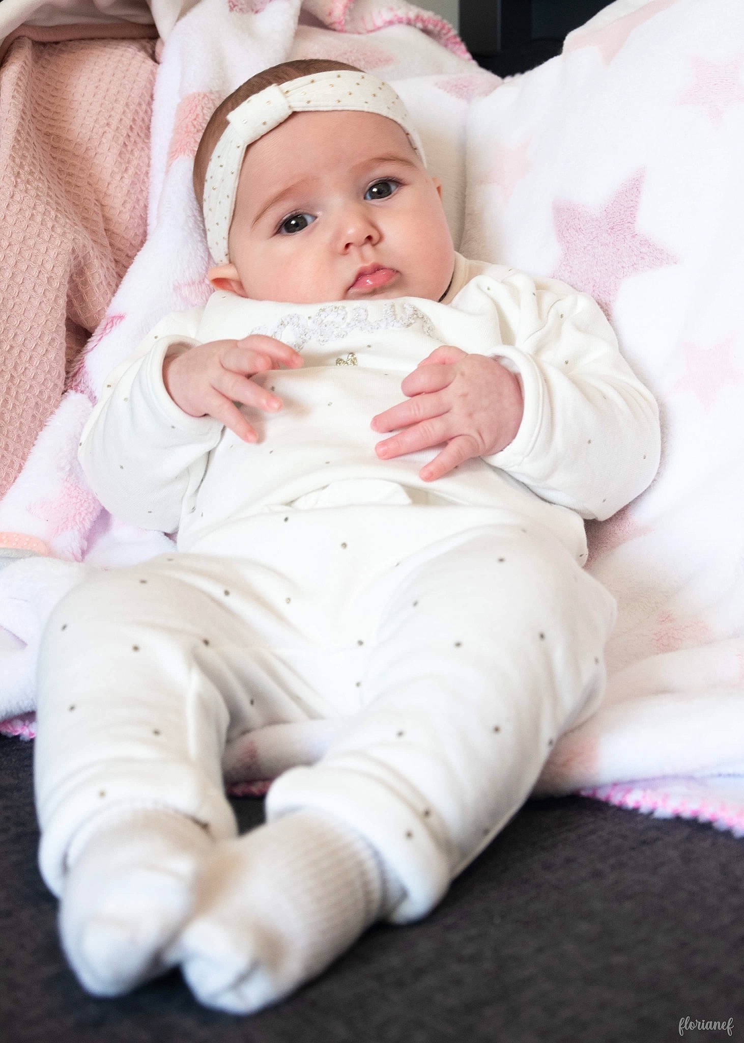 Lyana participe au concours pour gagner de l'argent avec cette photo : baby, baby_toddler_clothing, cap, cheek, child, collar, comfort, eye, fashion_accessory, fur, headwear, linens, lip, pattern, person, pink, portrait_photography, sitting, skin, sleeve