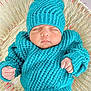 baby, basket, clothing, cozy, cute, face, hand, headwear, indoors, infant, knitted_hat, knitted_sweater, newborn, peaceful, portrait, resting, sleeping, soft_texture, turquoise, woven_basket