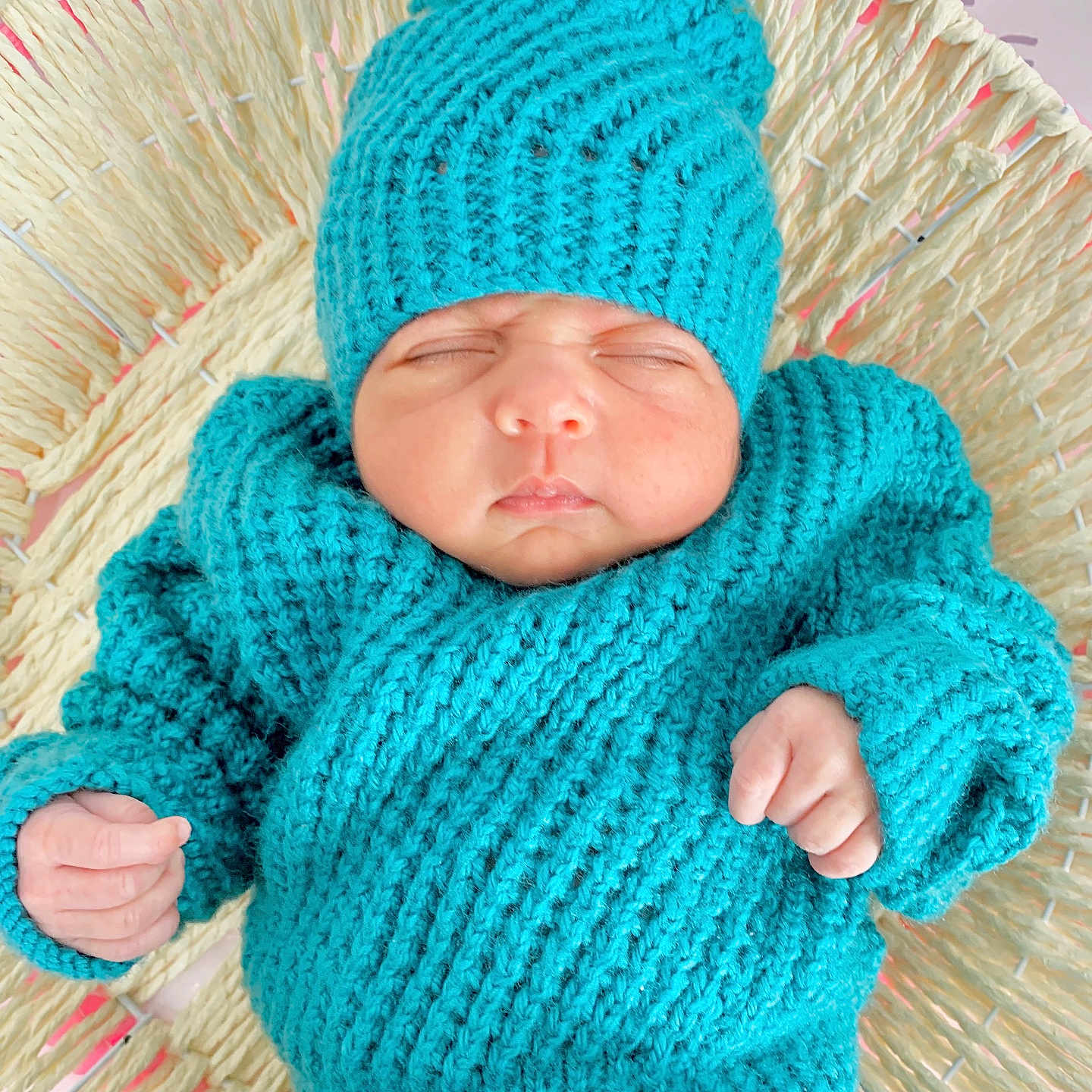 Samavia is registered to the contest to win money with this photo: baby, basket, clothing, cozy, cute, face, hand, headwear, indoors, infant, knitted_hat, knitted_sweater, newborn, peaceful, portrait, resting, sleeping, soft_texture, turquoise, woven_basket