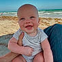 baby, beach, blue_sky, casual_clothing, child, hand, happy, holding, infant, legs, nature, ocean, outdoor, person, sand, seagull, skin, smiling, summer, waves