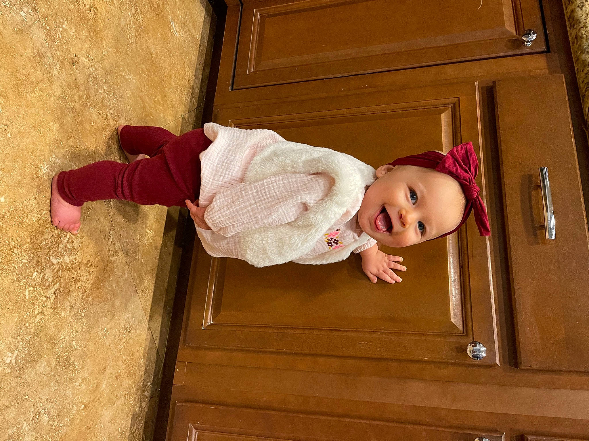 Sophia is registered to the contest to win money with this photo: baby, baby_products, baby_safety, baby_toddler_clothing, cabinetry, child, drawer, dress, flooring, happy, hardwood, magenta, pattern, person, pink, room, sleeve, smile, stairs, toddler