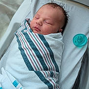 Ryder joined the competition — help win amazing prizes! newborn, baby, infant, swaddled, striped_blanket, bassinet, pacifier, sleeping, portrait, face, hair, cheeks, blanket, sheet, hospital, peaceful, cute, closeup, resting, hospital_bed