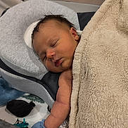 Ryder is registered to the contest to win money with this photo: baby, newborn, sleeping, blanket, boppy_pillow, crib, crib_mesh, pillow, mittens, arm, face, closed_eyes, hair, bedding, nursery, indoor, resting, cozy, blanket_texture, portrait