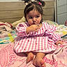 toddler, child, baby, bed, blanket, pink, dress, pigtails, hair_ties, indoor, furniture, mirror, cute, person, foot, hand, striped, plush, cozy, curious