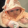 baby, infant, child, hood, mitten, cartoon_character, minnie_mouse, pink_clothing, soft_texture, blanket, cute, face, eyes, person, portrait, warm_clothing, indoor, closeup, babywear, adorable