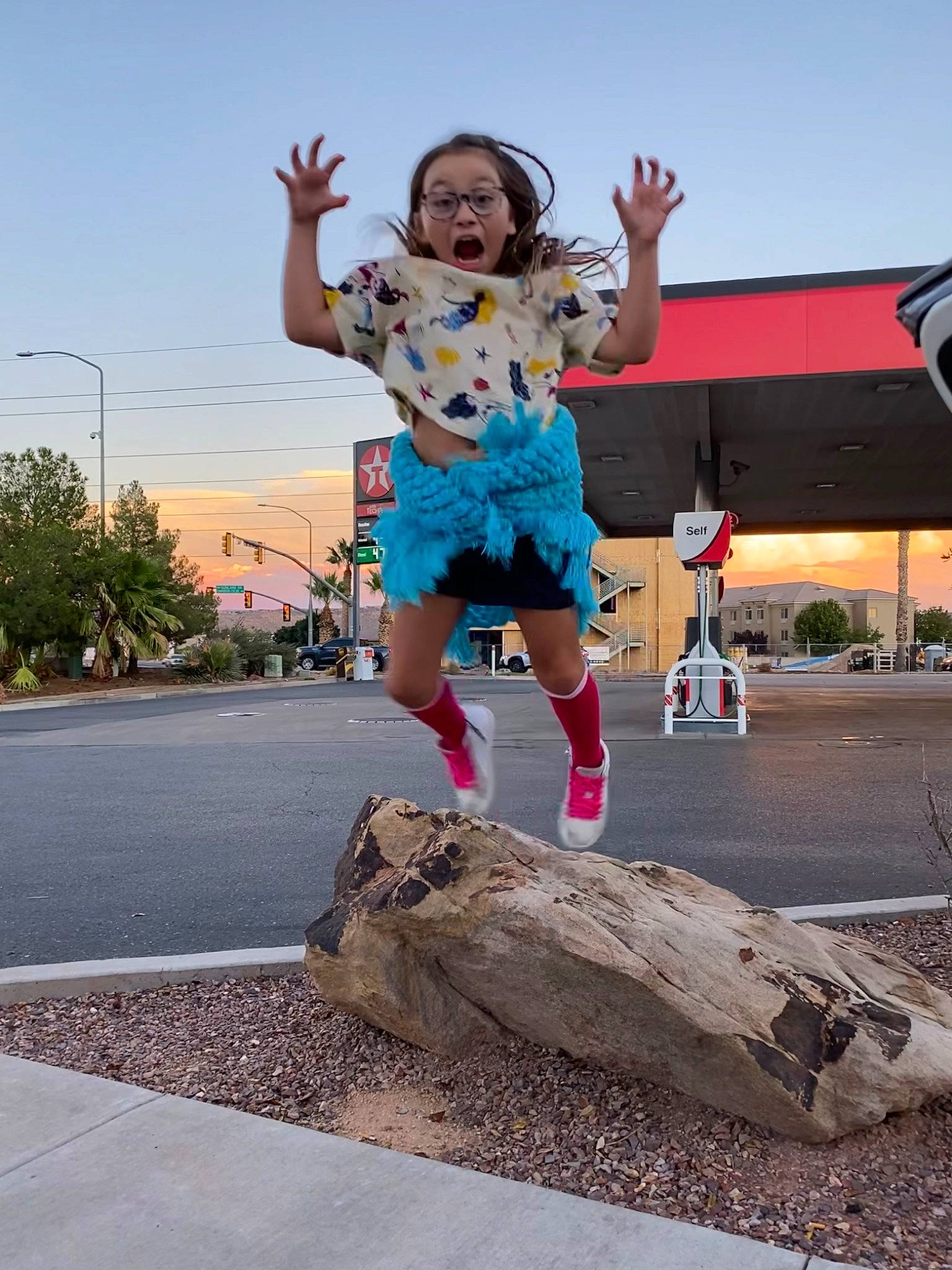 Athena is registered to the contest to win money with this photo: asphalt, child, city, fun, gesture, happy, leisure, person, plant, recreation, road, shorts, sky, soil, street, street_light, surprise, t_shirt, toddler, tourism
