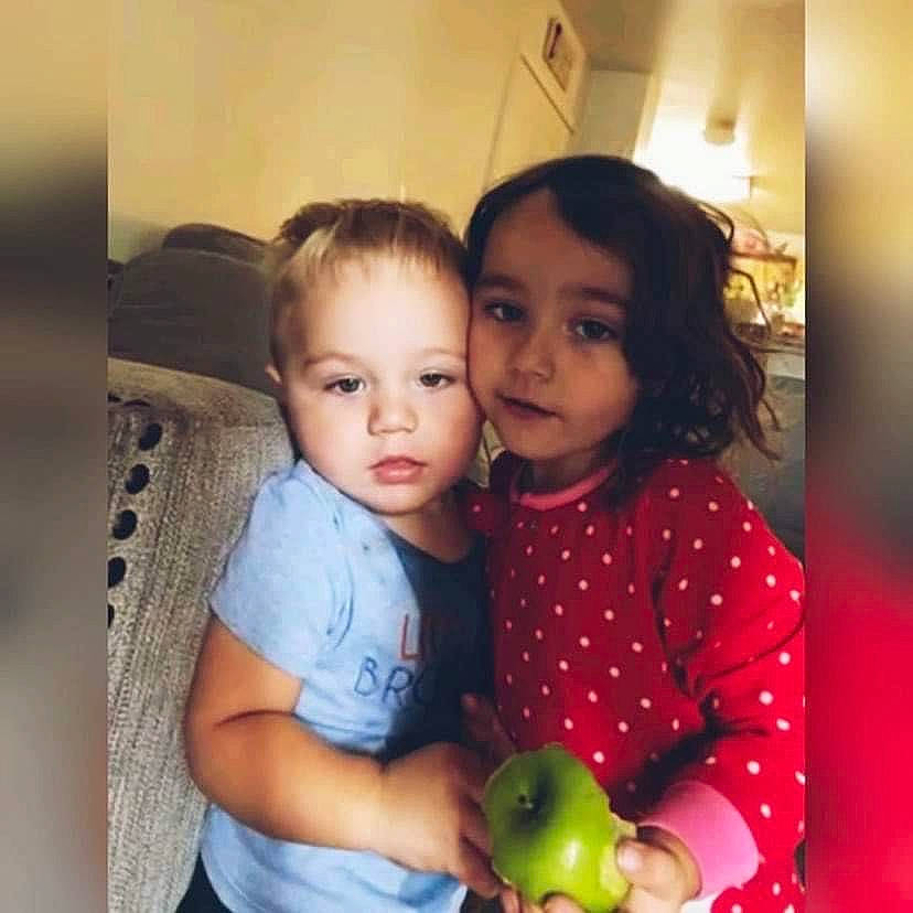 Kyra is registered to the contest to win money with this photo: apple, baby, chair, cheek, chest, child, event, fruit, fun, happy, iris, nose, person, room, sharing, sitting, skin, sleeve, snapshot, t_shirt