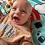 Jayden is registered to the contest to win money with this photo: baby, child, clothing, colorful, cute, expression, fabric, face, happy, head, indoor, infant, lion, person, play_mat, plush, portrait, smiling, toddler, toy