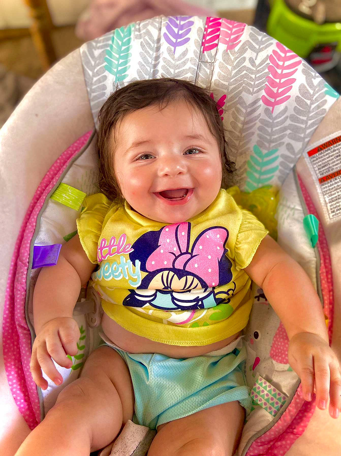 Mariyana is registered to the contest to win money with this photo: baby, baby_toddler_clothing, cheek, eye, face, facial_expression, finger, green, happy, head, joy, leg, neck, organ, person, pink, skin, sleeve, smile, textile