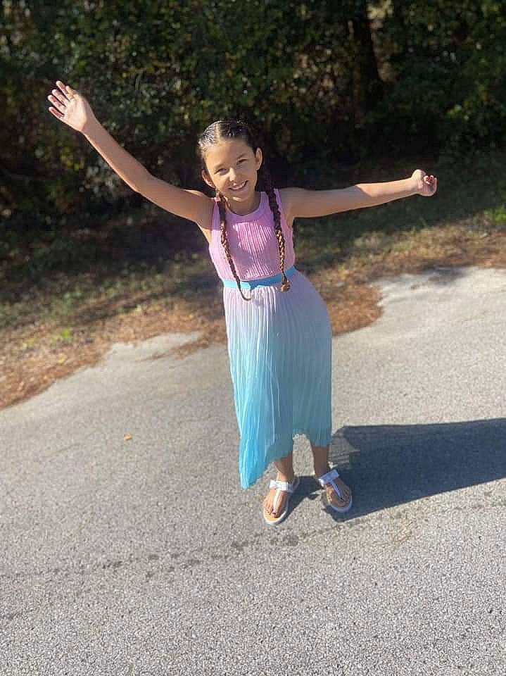 Brianna is registered to the contest to win money with this photo: asphalt, barefoot, electric_blue, event, fun, gesture, grass, happy, joy, landscape, leg, leisure, people_in_nature, person, plant, recreation, road, road_surface, soil, tree