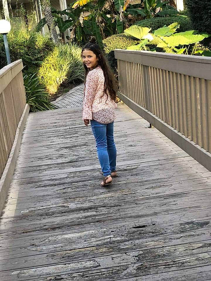 Brianna is registered to the contest to win money with this photo: denim, electric_blue, footwear, grass, human_leg, jeans, joy, leg, leisure, pattern, pedestrian, person, photograph, plant, road, road_surface, sidewalk, sleeve, thigh, waist