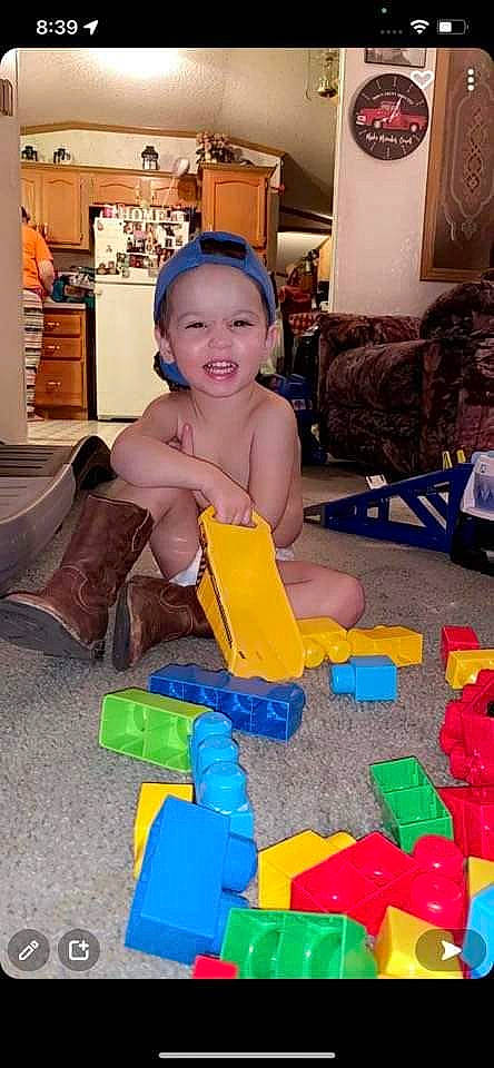 Reed is registered to the contest to win money with this photo: baby, baby_toys, child, comfort, couch, flooring, fun, happy, headwear, leisure, person, picture_frame, plastic, play, product, recreation, room, sitting, smile, toddler