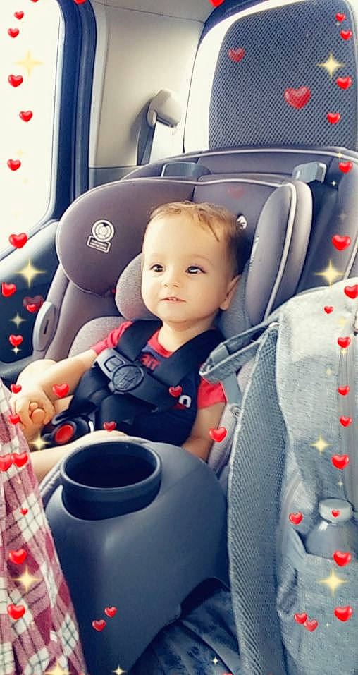 Reed is registered to the contest to win money with this photo: auto_part, automotive_design, baby, car, car_seat, car_seat_cover, carmine, child, family_car, fun, head_restraint, luxury_vehicle, motor_vehicle, person, plastic, smile, steering_wheel, toddler, vehicle, vehicle_door