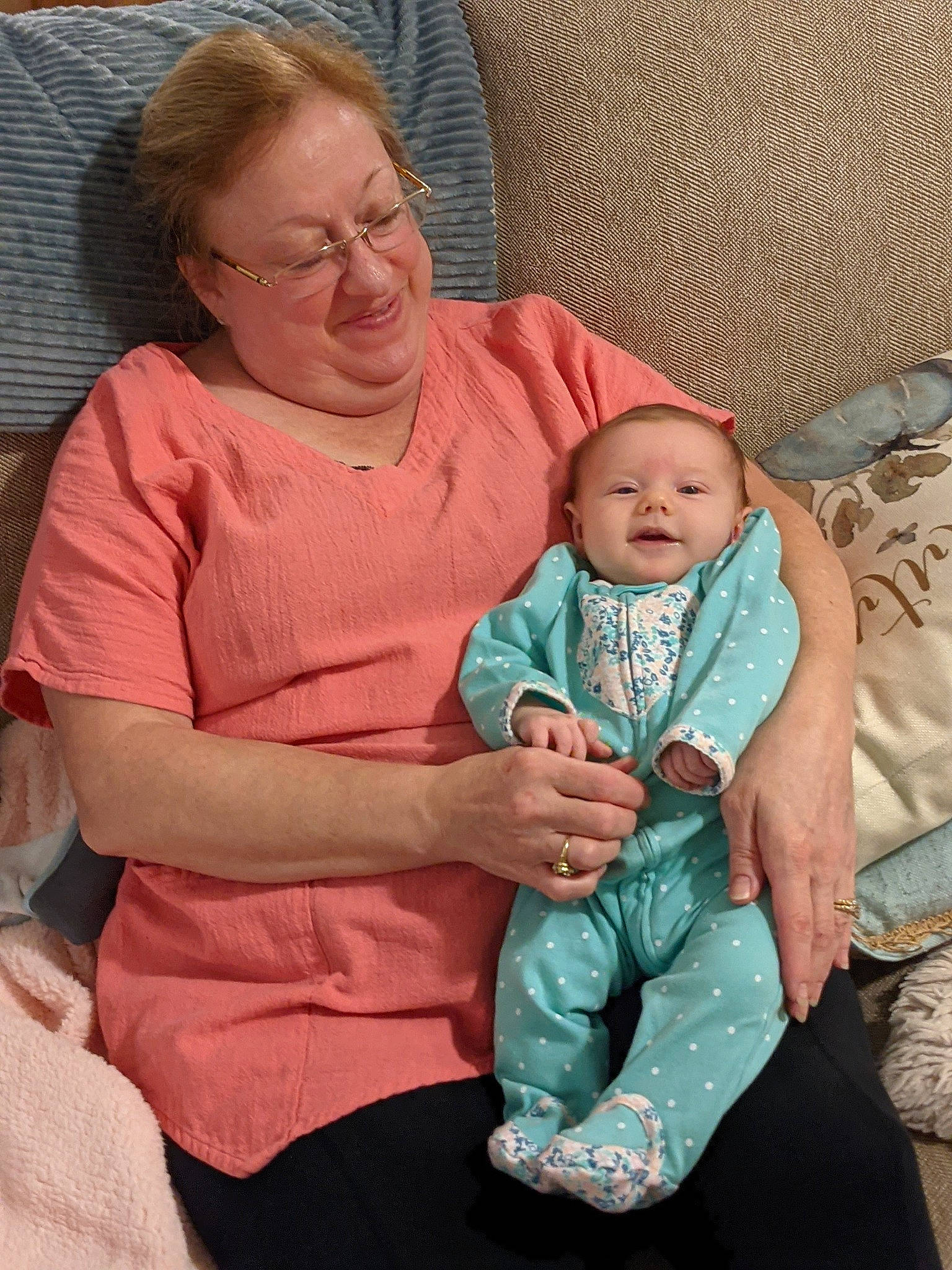 Estelle is registered to the contest to win money with this photo: baby, baby_products, baby_toddler_clothing, cheek, child, comfort, event, face, finger, fun, happy, human_body, lap, mouth, person, pink, sitting, skin, smile, toddler