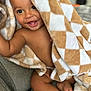 Coltan is registered to the contest to win money with this photo: baby, blanket, child, comfort, couch, cozy, cute, expression, face, happy, indoors, infant, plush, portrait, relaxed, skin, smiling, soft, wrapped, young