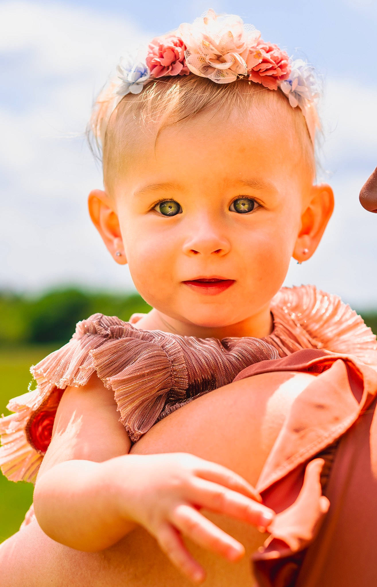 Madelyn joined the competition — help win amazing prizes! baby, baby_toddler_clothing, chin, eye, facial_expression, flash_photography, flower, gesture, grass, happy, head, human, people_in_nature, person, pink, skin, sky, sleeve, smile, sunlight