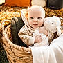 baby, basket, plush_toy, hoodie, striped_clothing, pumpkin, flowers, autumn, cozy, woven, grass, blanket, smiling, cute, child, portrait, outdoor, soft_toy, happy, nature
