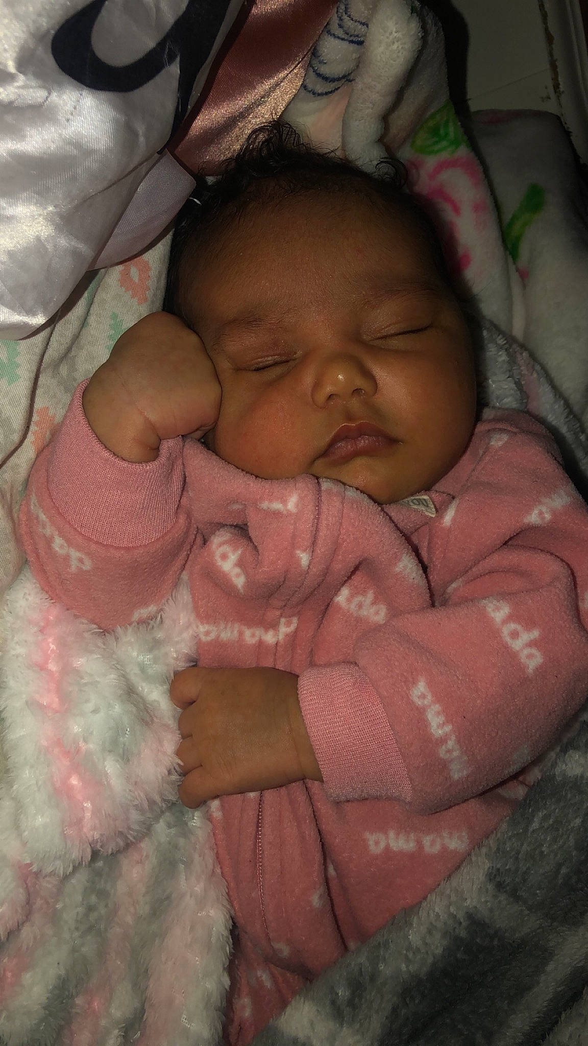 Prudence is registered to the contest to win money with this photo: arm, baby, baby_products, baby_toddler_clothing, bedtime, brown, cheek, chin, comfort, eyebrow, finger, happy, iris, linens, lip, mouth, nose, person, pink, skin