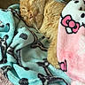 blanket, cat, closed_eyes, cozy, curled_up, cute, feline, fur, hello_kitty, indoors, nap, orange_cat, pet, pink, plush_blanket, portrait, sleeping, soft_texture, turquoise, whiskers